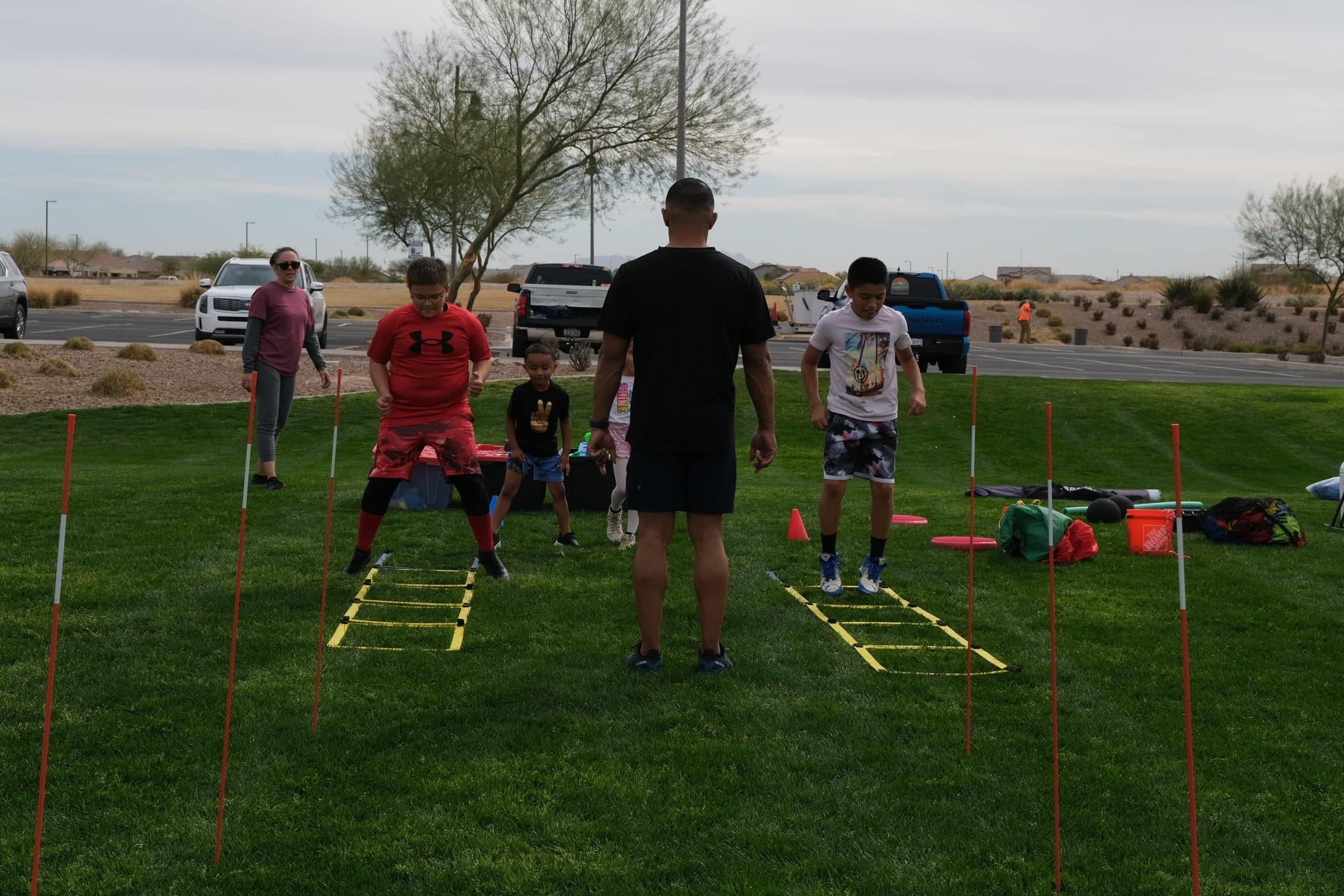 Diverse families and children playing together outdoors in a sunny Arizona park